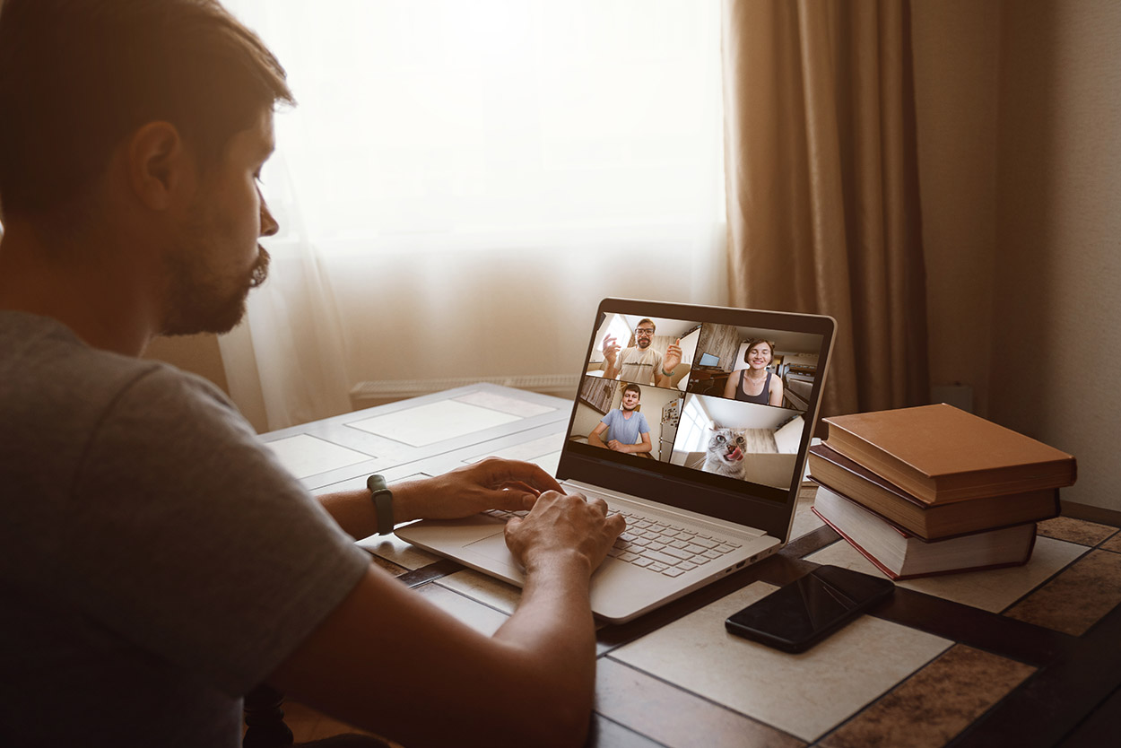 Man Working From Home Having Online Group Videoconference On Laptop